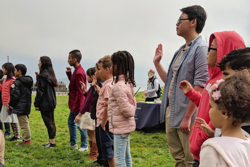 Taking the oath of allegiance as new U.S. citizens