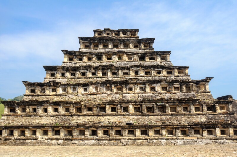 A stone pyramid with seven levels and dozens of niches, or windows, carved into each level