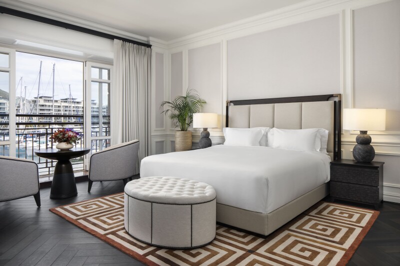 This one-bedroom suite at Cape Grace in Cape Town has dark hardwood floors, geometric carpets, and harbor views.