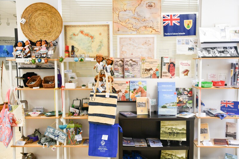 Wall of rows of small items, such as brochures and souvenirs, at Turks and Caicos National Museum
