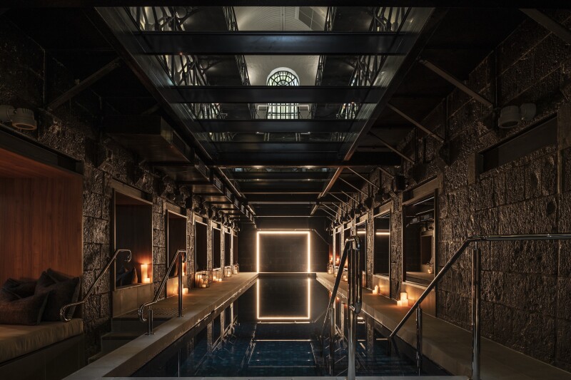 Stone walls around the underground pool, with dim lighting