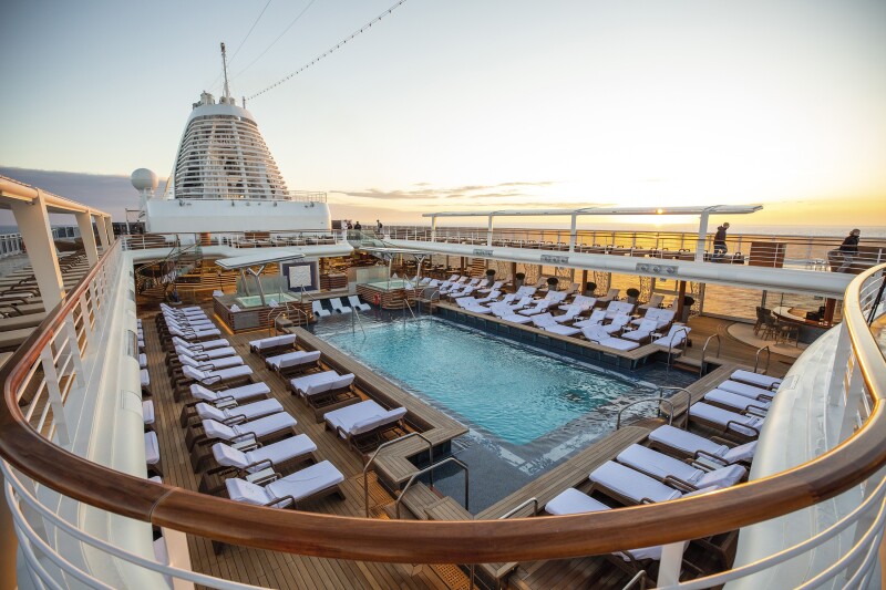 The top deck pool area on Regent's 'Seven Seas Splendor' surrounded by white loungers