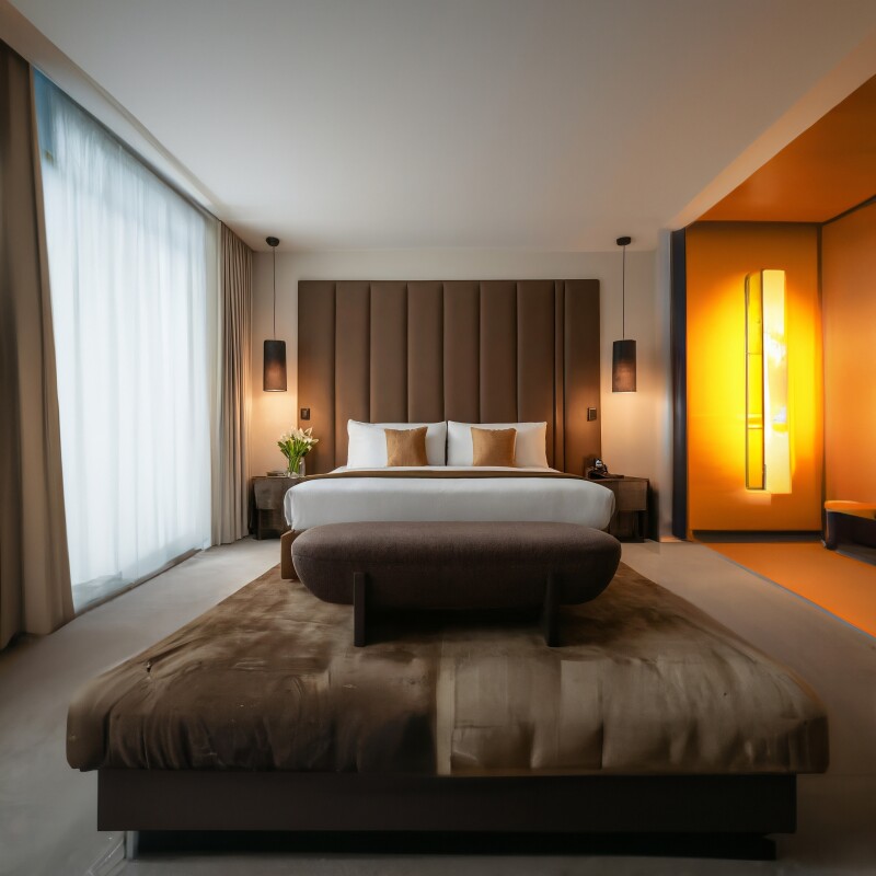 In this AI-generated photo of a hotel room, the tell that it's not real is the rug become a bench towards the bottom of the image.