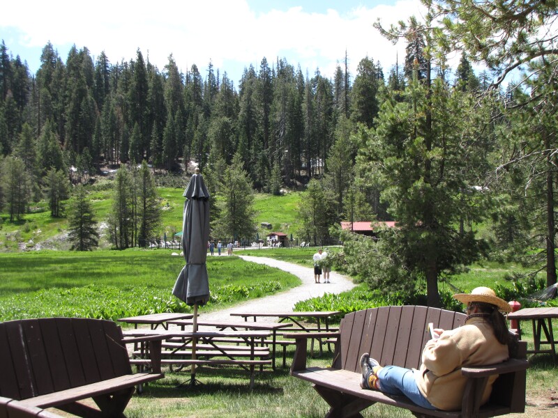 Woman relaxing with a book at Drakesbad Guest Ranch.