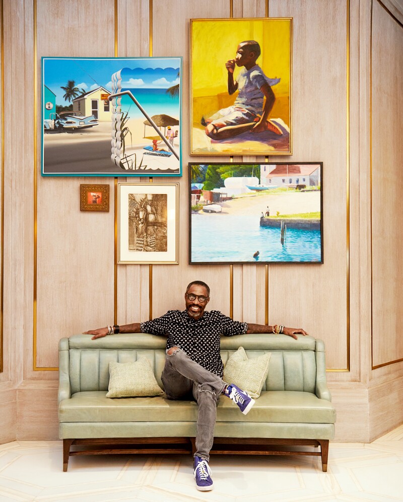 John Cox sits beneath Bahamian artworks at the Baha Mar Resort.