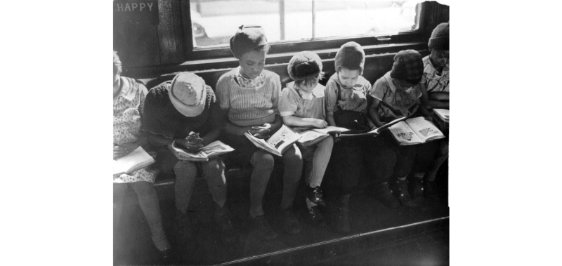 Children reading in a window at the Quincy Branch Library, now named the Langston Hughes Branch