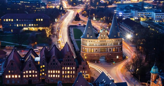 A birds-eye view of cars driving along the roads at night in Lübeck, Germany