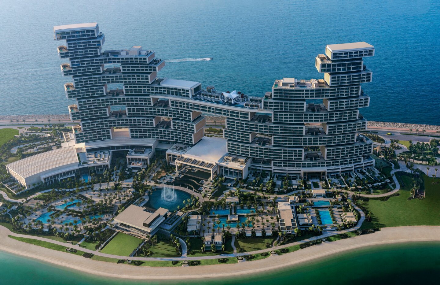 aerial view of the Atlantis The Royal, Dubai hotel. The hotel looks like stacked boxes and is on a peninsula of land surrounded by ocean