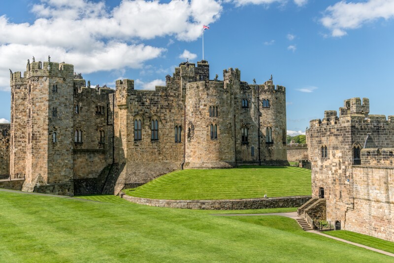 The grass-covered grounds of Alnwick Castle
