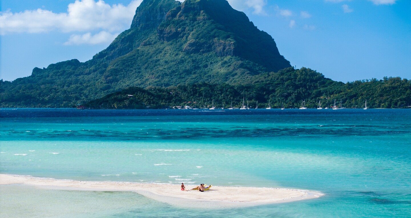 People enjoying a private beach on Bora Bora
