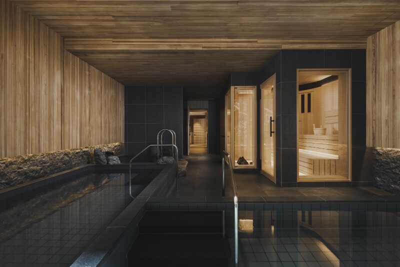 The sauna area of the Six Senses Kyoto spa is covered with wood and dark stone.