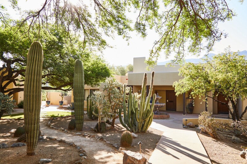 The entry to a guest room at Miraval Arizona is decorated with cactus and simplistic landscaping.