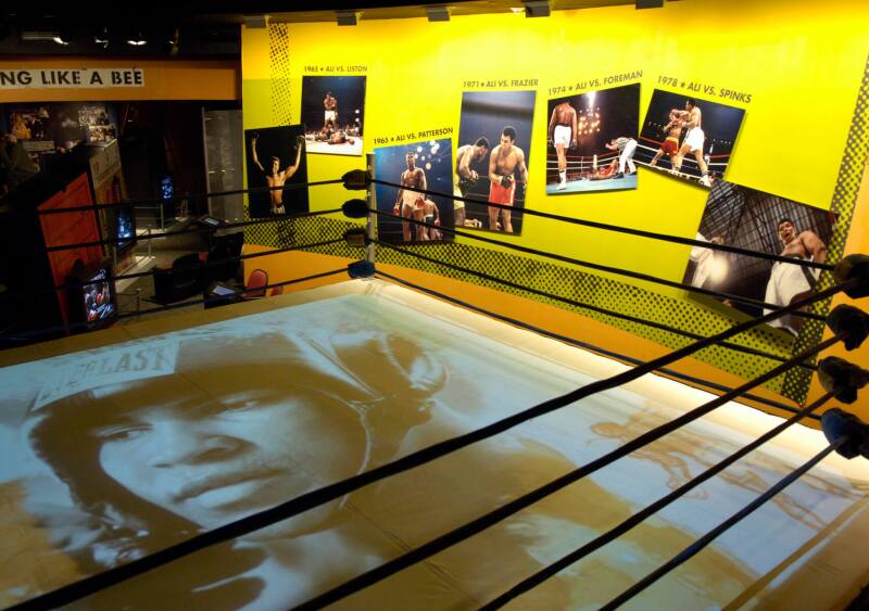 Overhead view of exhibit about Muhammad Ali, with boxing ring in foreground