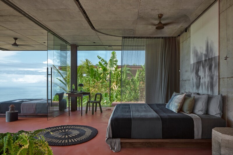 Bedroom with glass walls open to let views in