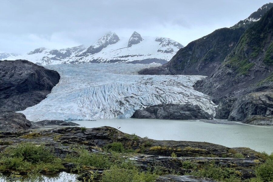 Chunks of ice in water near mountains