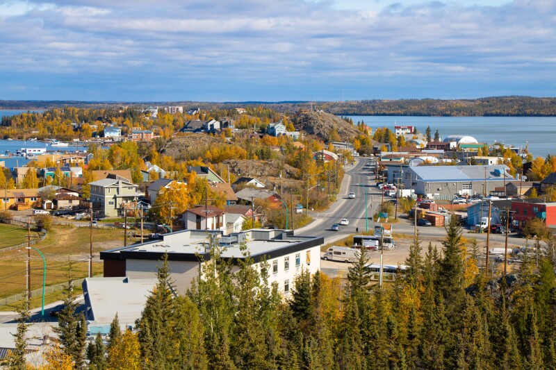 A small city on the edge of a lake, with fall foliage