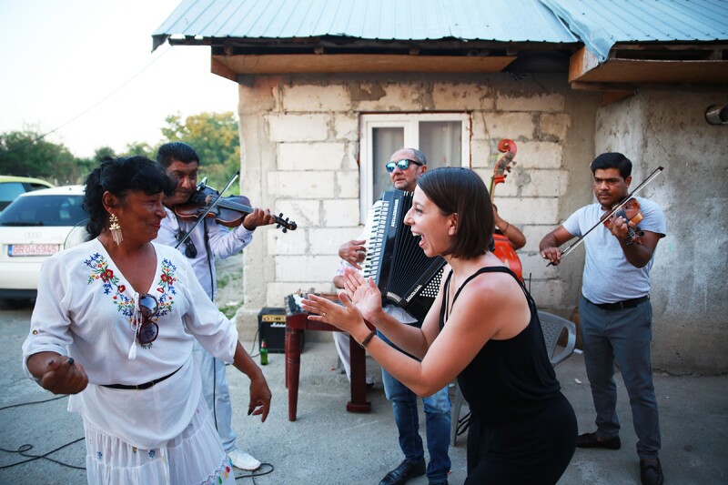 Episode five takes Mallozzi to the Roma village of Clejani, Romania, where she dances with world-renowned Gypsy band, Taraf de Caliu.