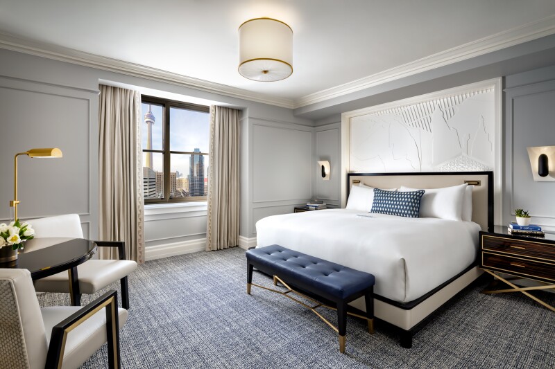 A Fairmont Gold King room at the Fairmont Royal York with blue carpeting and views of Toronto.