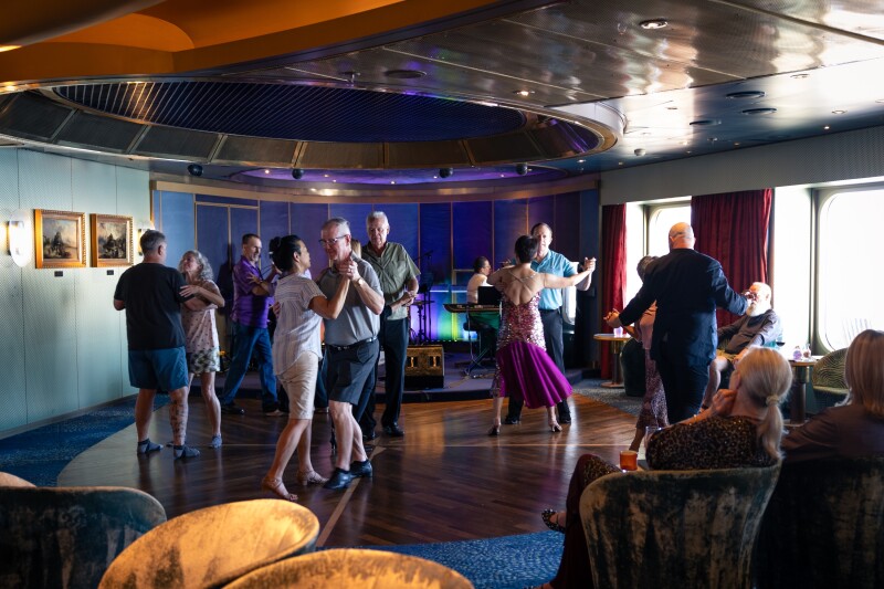 Five pairs of passengers dancing