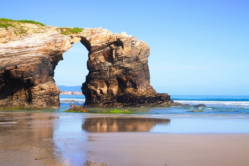 Nature-carved rock sculptures mark the seascape at Spain’s Praia de Augas Santas.