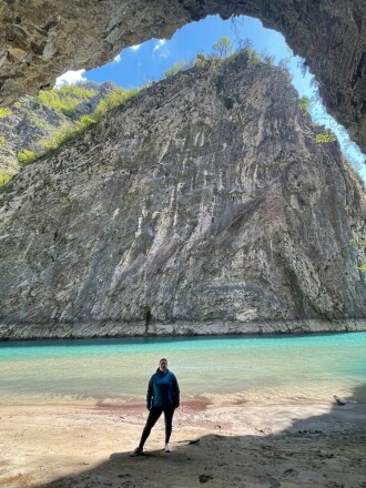 Woman standing in front of lake in Albania