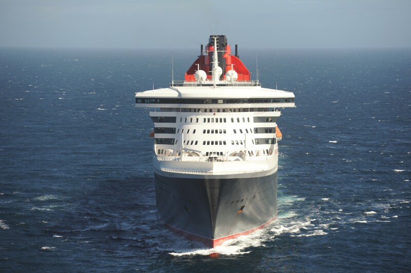 View of the front of British line Cunard's 'Queen Mary 2' ocean cruise ship with a black hull and white body