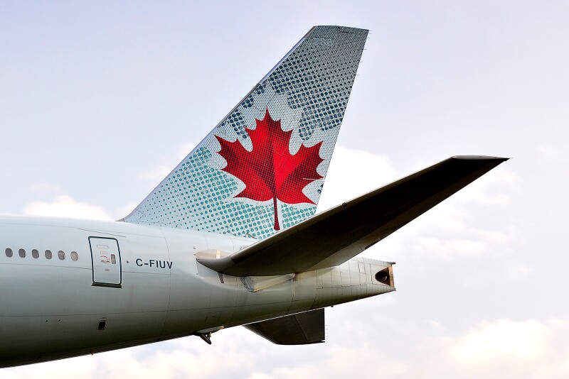 Tail of Air Canada airplane with red maple leaf design