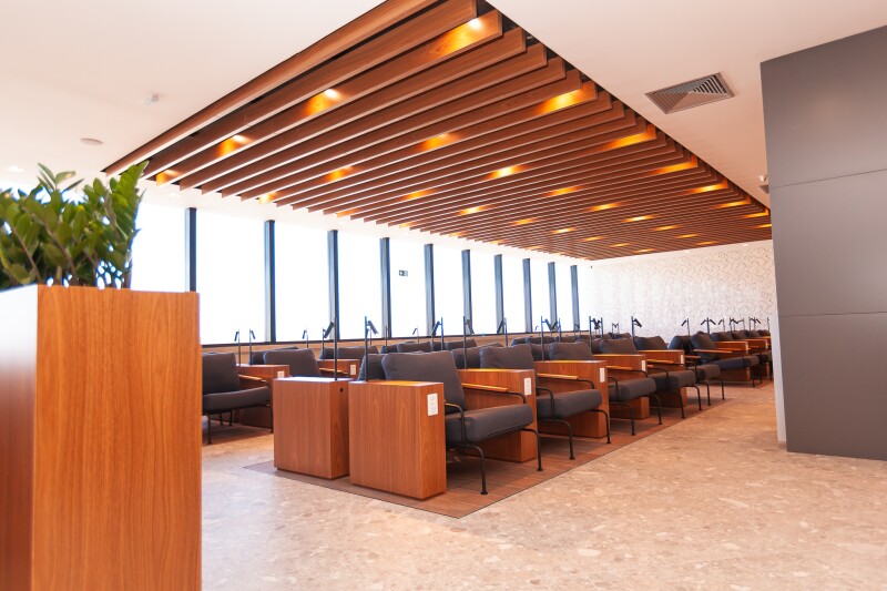 Individual gray seats with lights and power plugs at the Brazil Advantage VIP airport Lounge in Belo Horizonte airport