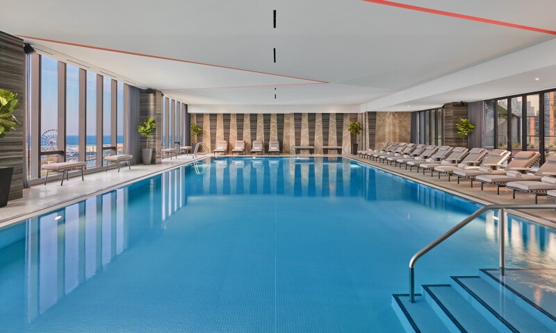 The pool at the St. Regis Chicago has floor-to-ceiling windows with a view of the city.