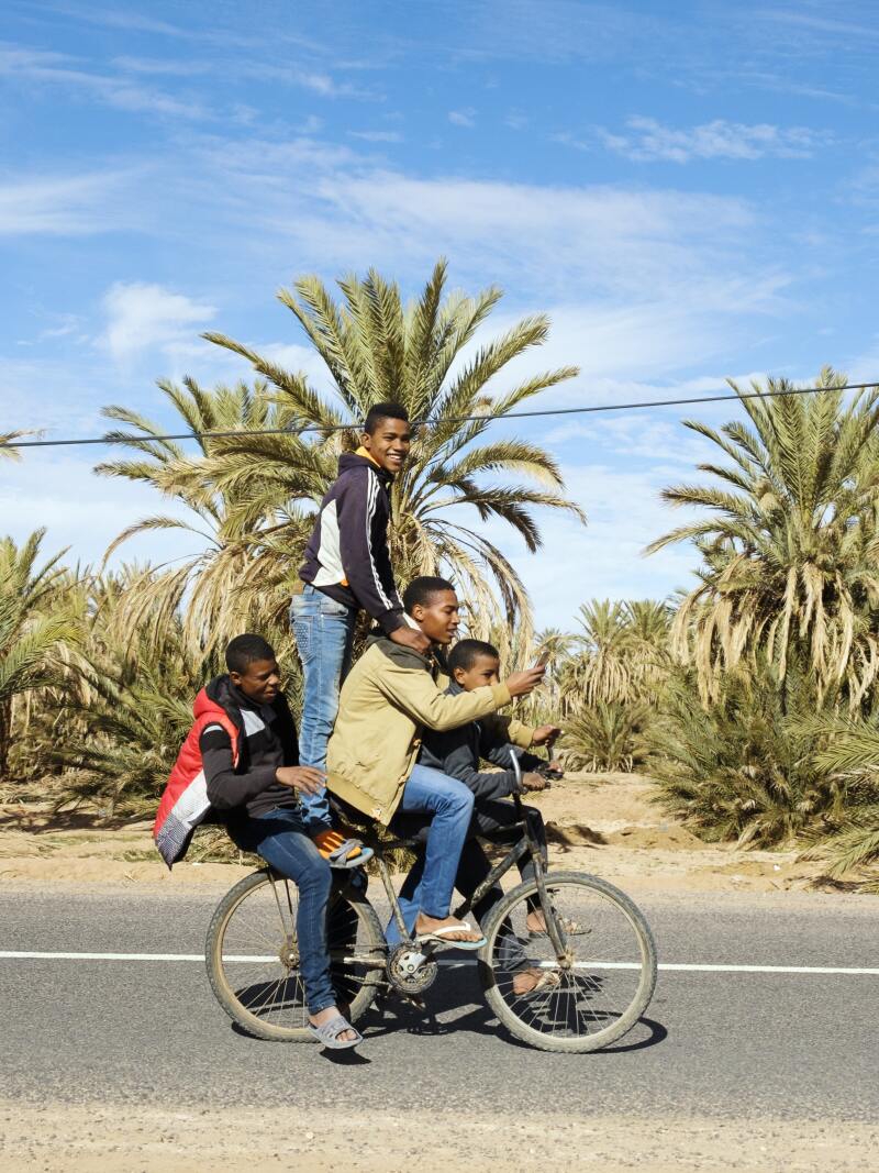 Boys ride on a street in Oulad Edriss, south of Zagora.