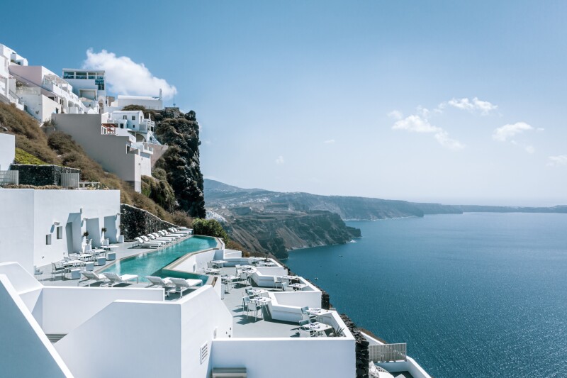 The cliffside pool at white Grace Hotel in Santorini, Greece, with views of the Aegean Sea