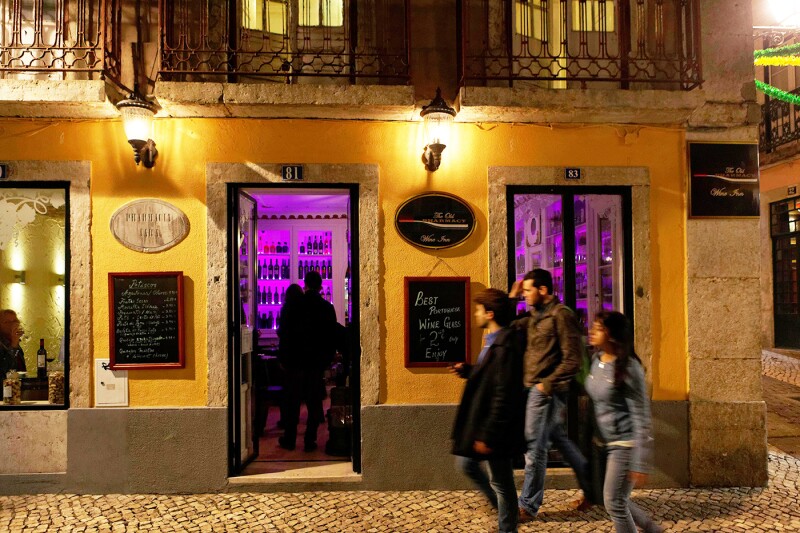 Fuschia lights in antique glass cabinets radiate throughout the main room at the Old Pharmacy.