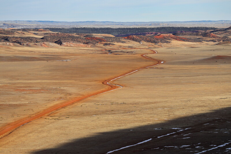 A dirt road winding through the desert of Casper, Wyoming