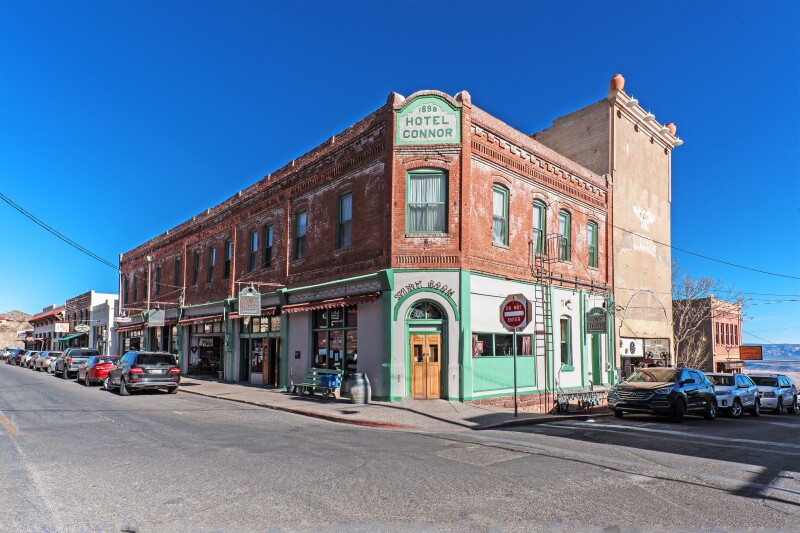 Two-story red brick building with the words "Hotel Connor" at top corner
