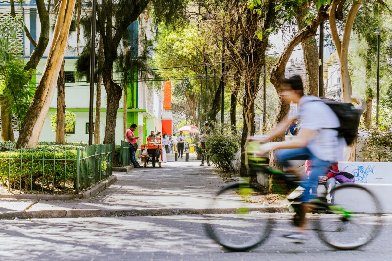 A biker speeds past in the Plaza de Rio de Janeiro in the Roma Norte neighborhood of Mexico City.