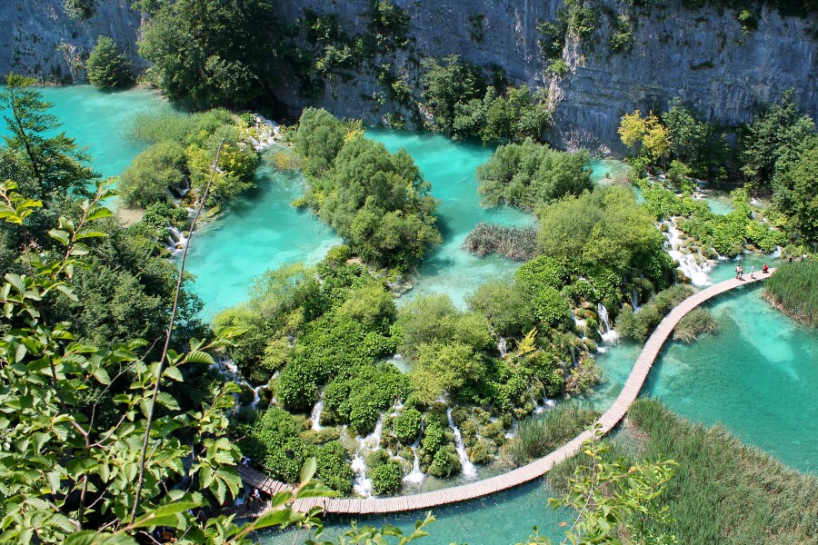 Walking across the turquoise pond at Plitvice Lakes National Park, which covers nearly 30,000 hectares.