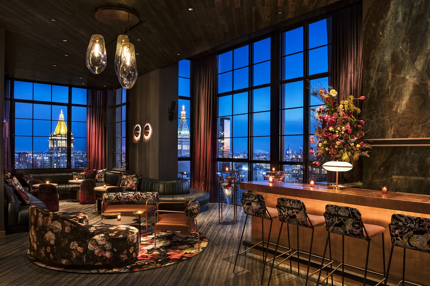 The Fleur Room at dusk, with views of city from tall windows
