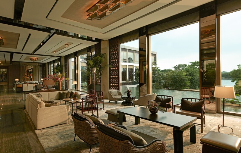 The Tea Lounge at Capella Bangkok, with sofa, seats, and tables, plus wall of windows open Chao Phraya River