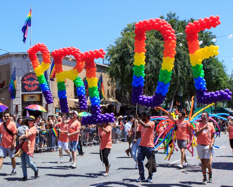 Los Angeles Pride Parade with Pride spelled out in balloons in the colors of the rainbow flag
