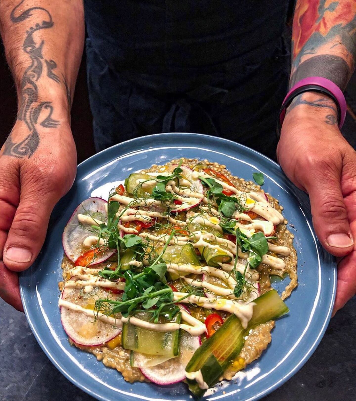 Reyla’s eggplant dish comes with topped with chilies, radishes, tahini, and persimmon sauce.