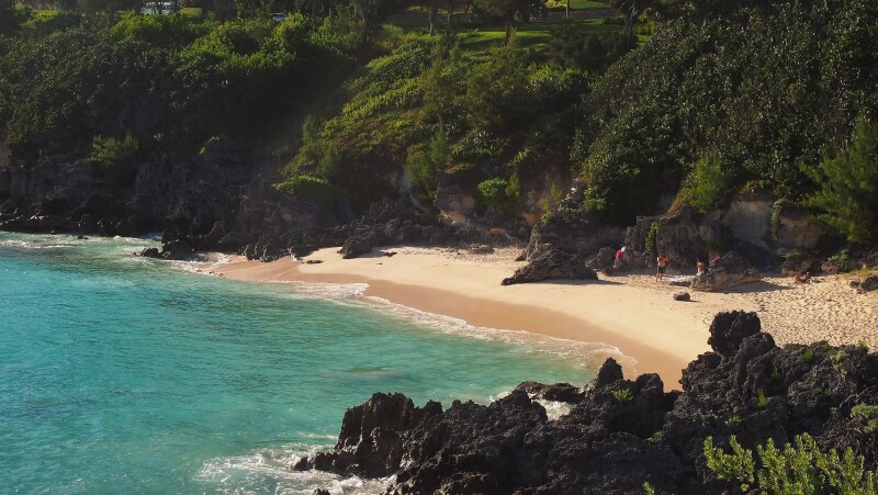 Turquoise water hitting a sandy shore