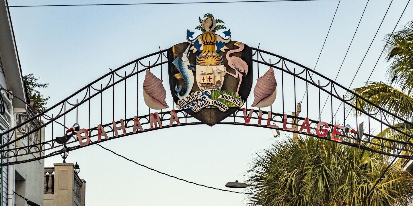 Crest atop gate to Bahama Village, with sailfish and flamingo in profile