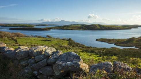 A view of stone walls and lakes over Sky Road in Galway County