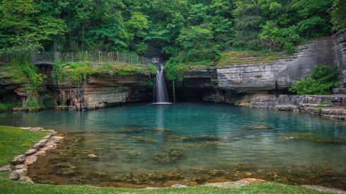 A waterfall in a quiet pond