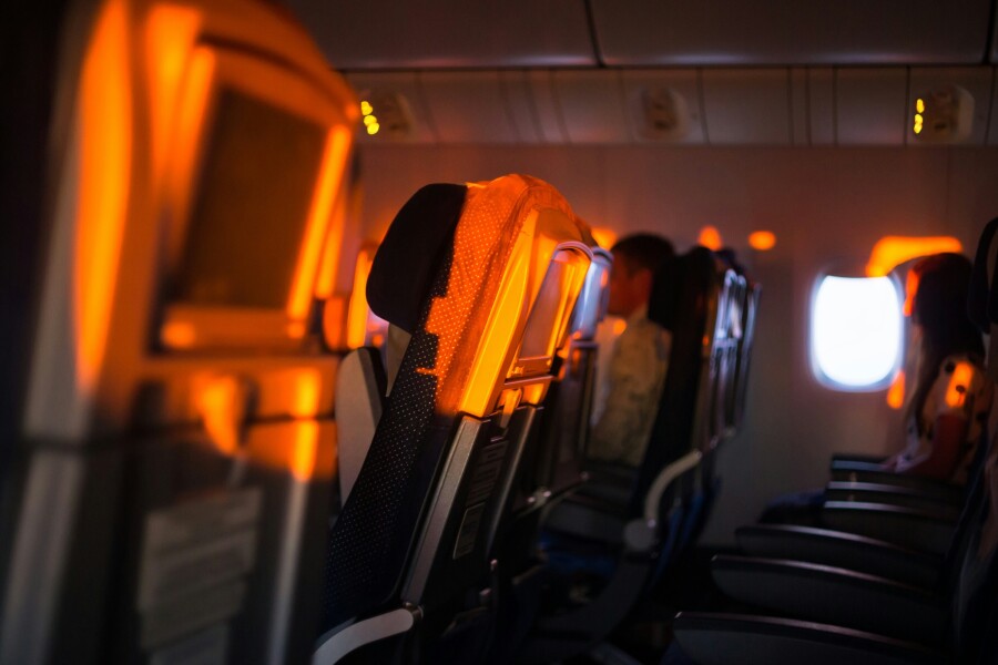Side view of a row of airline seats in golden light from window